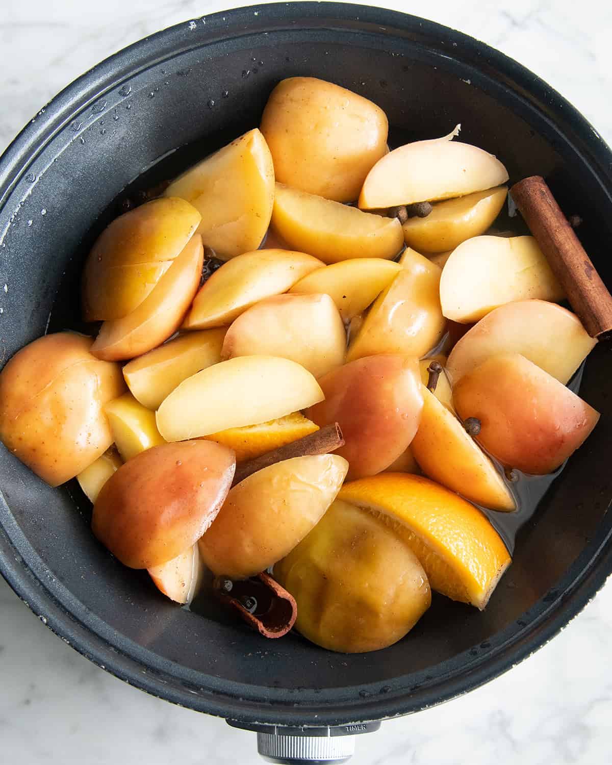 how to make apple cider recipe - ingredients in the crock pot after cooking for 4 hours