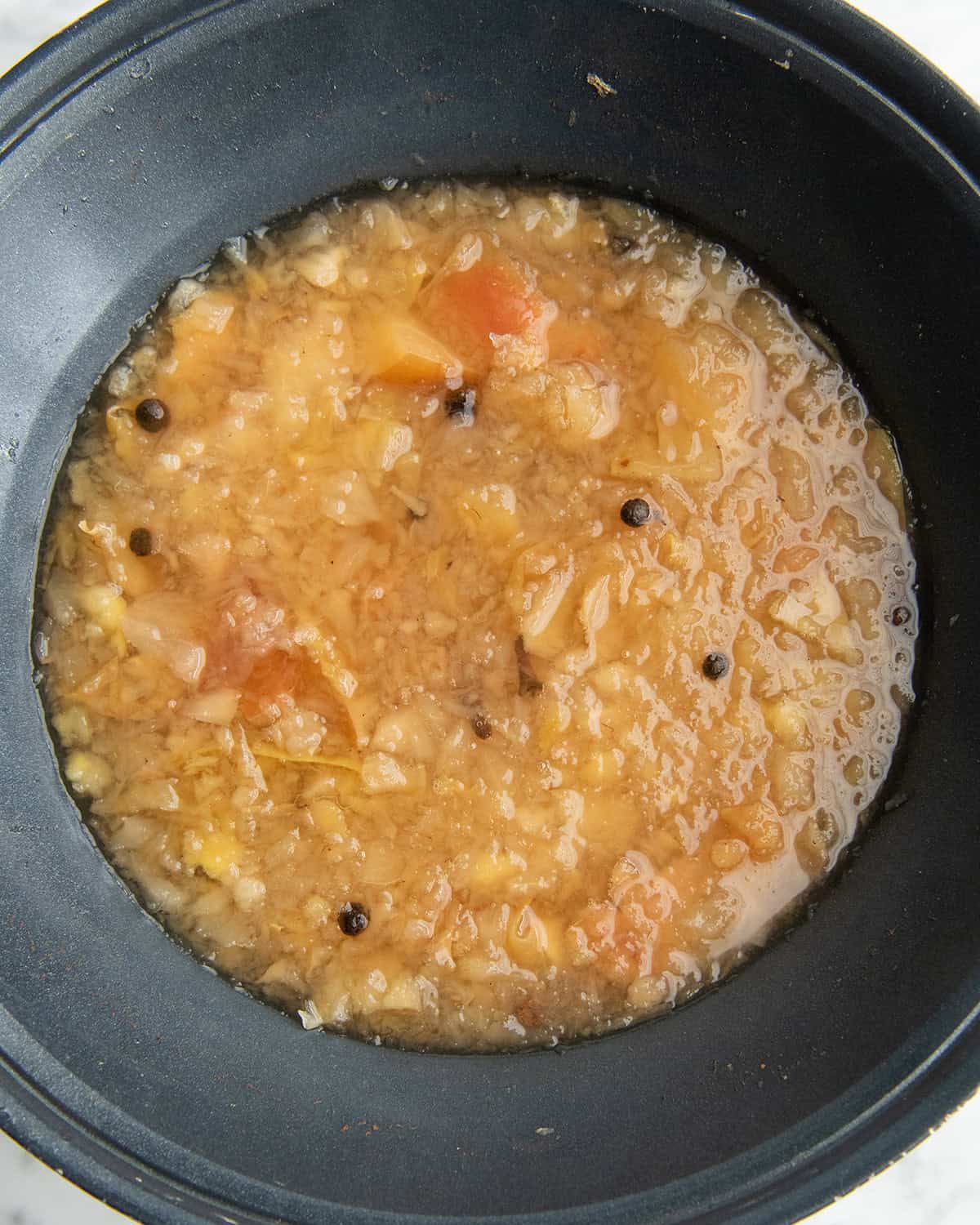 how to make apple cider recipe - mashed apple cider mixture after cooking for 1 hour in a crock pot