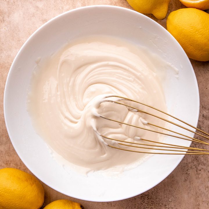 lemon glaze being whisked together in a white bowl