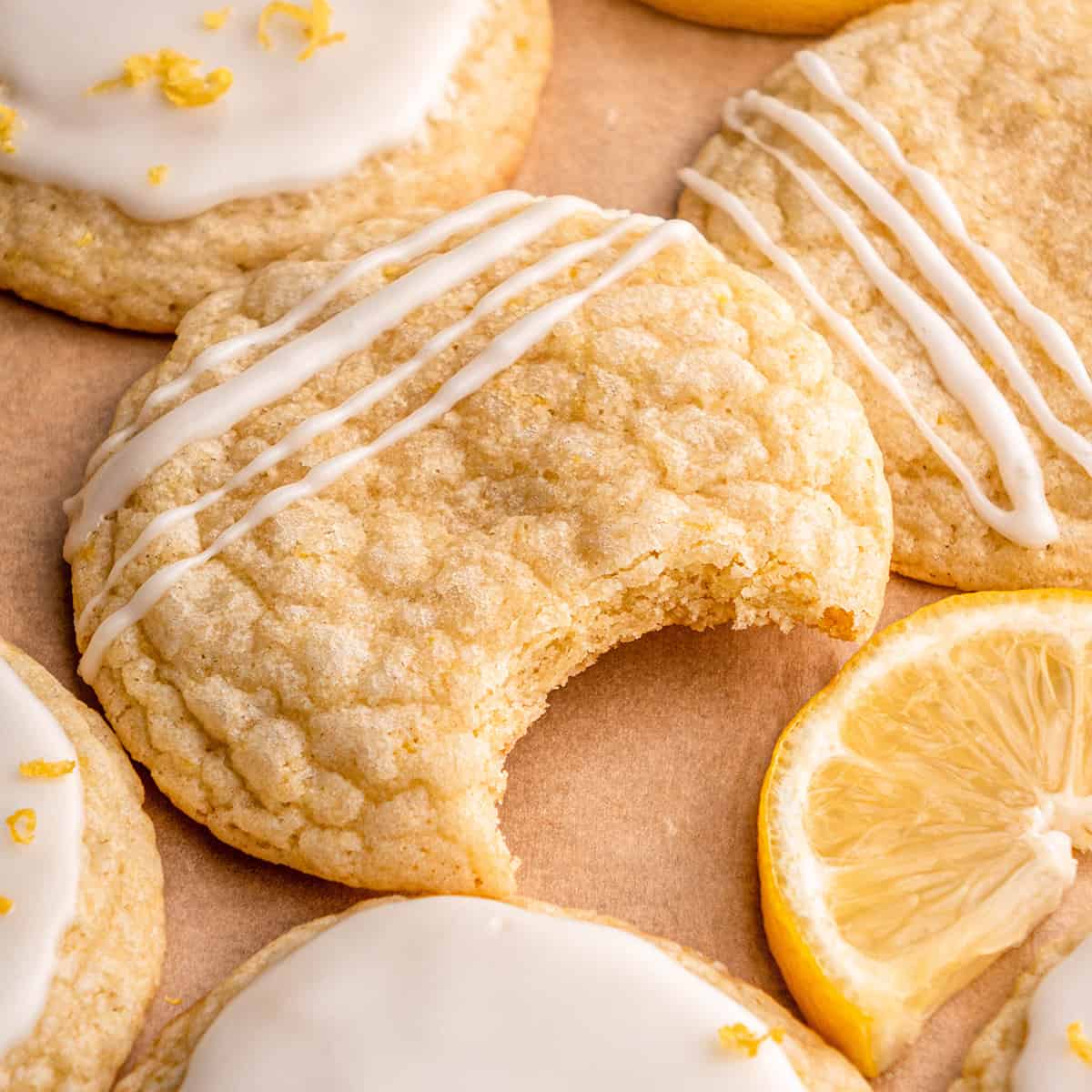 a lemon cookie drizzled with lemon glaze with a bite taken out of it
