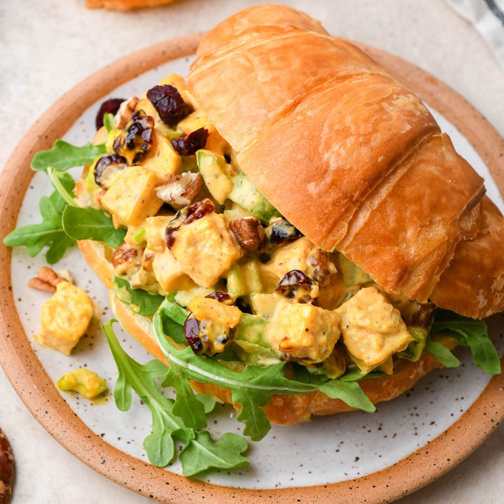 front view of Cranberry Chicken Salad inside a croissant on a plate