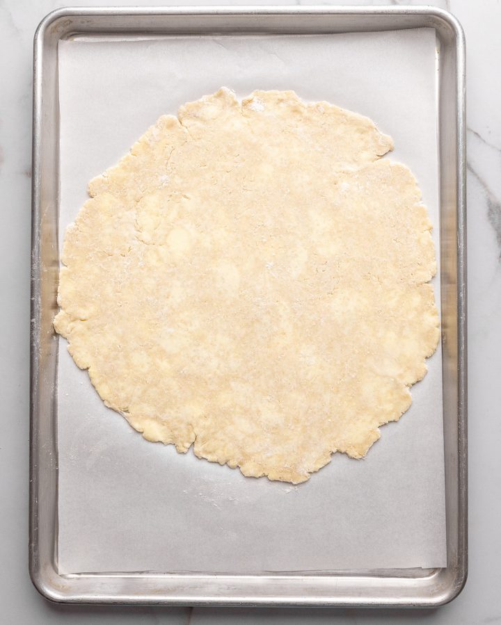 galette dough rolled out onto a large baking sheet