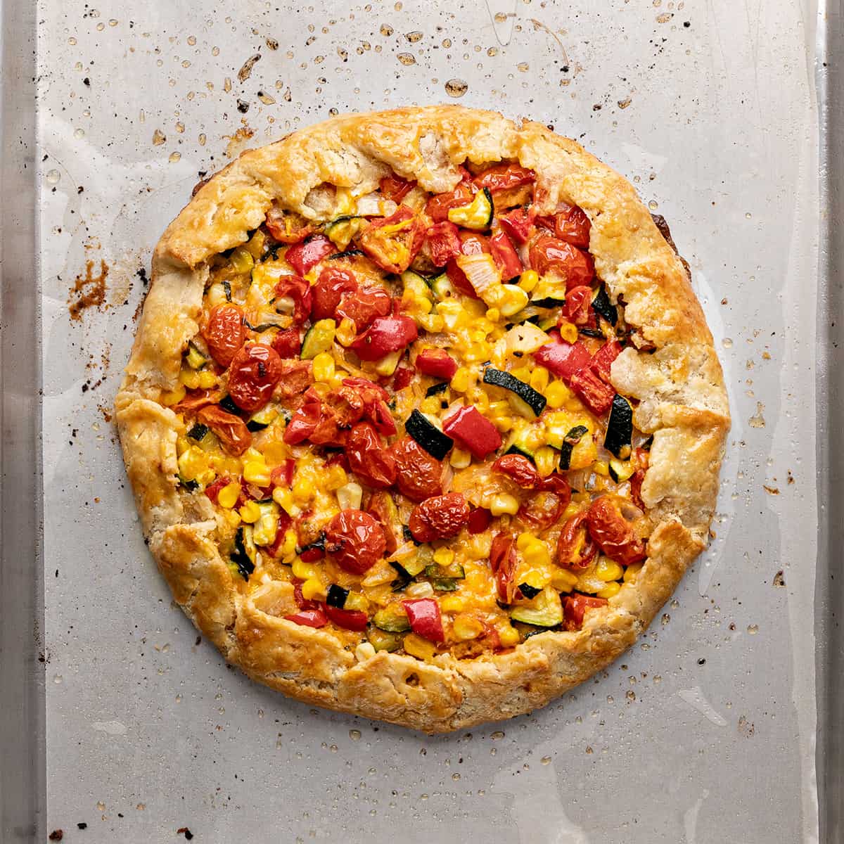 savory galette on a baking pan after baking