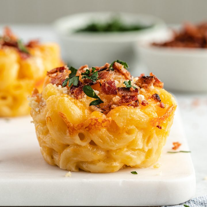 Baked Mac & Cheese Cups topped with crumbled bacon and parsley