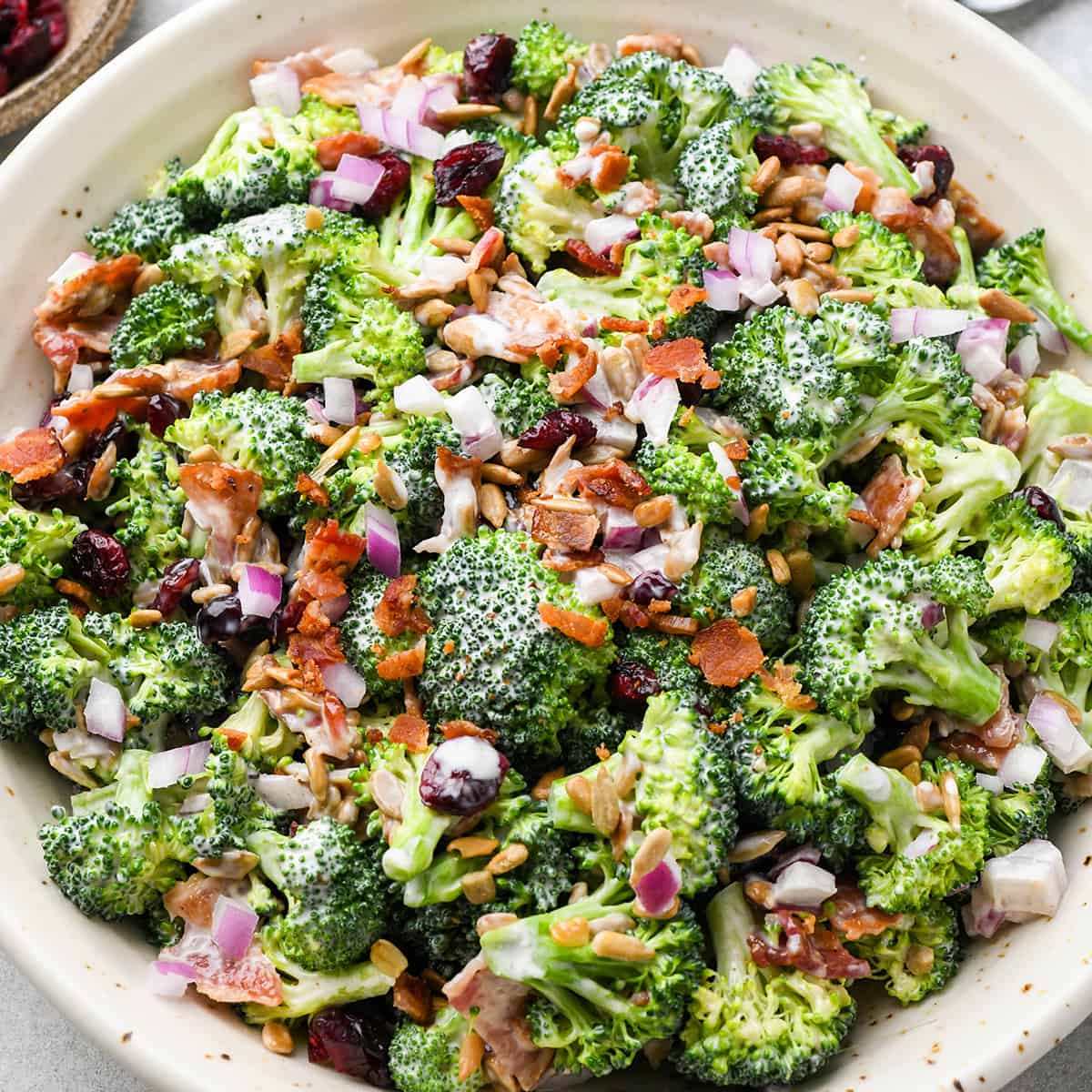 a bowl of Broccoli Salad with bacon and cranberries