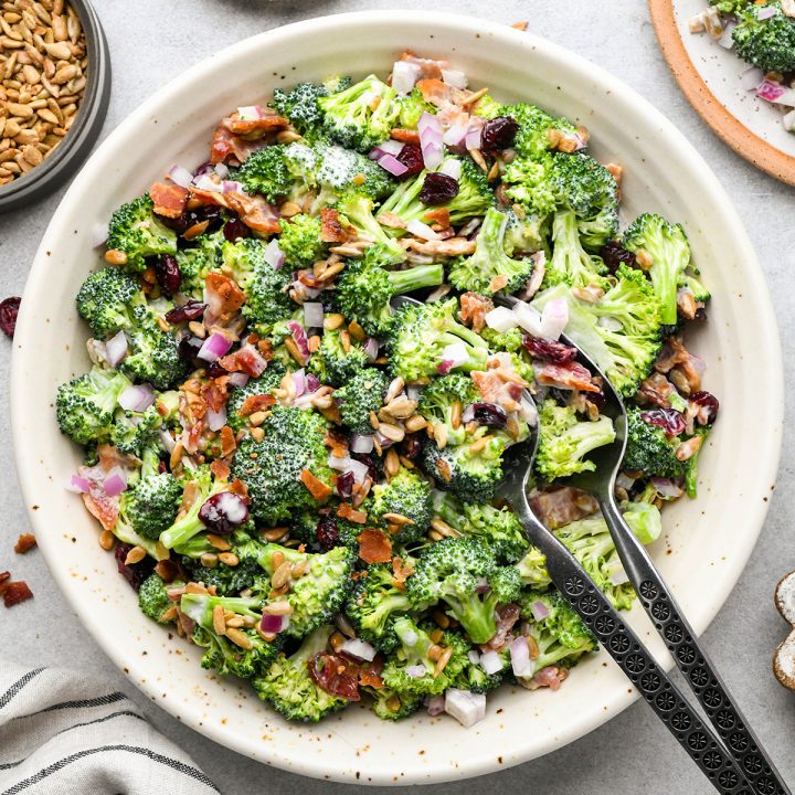 Broccoli Salad in a bowl with two serving spoons