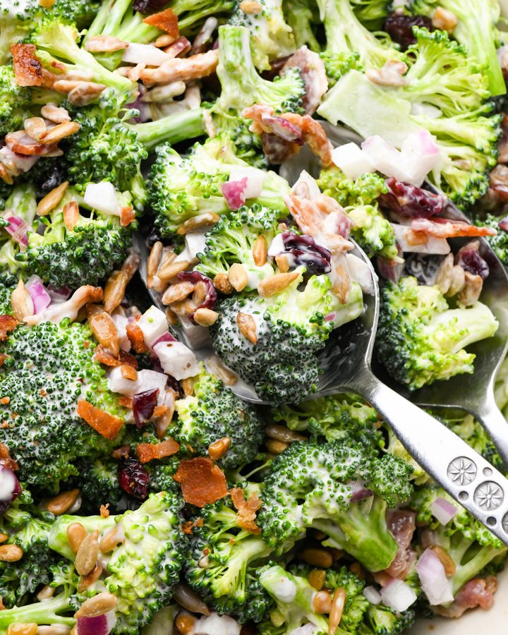 a spoon taking a scoop of Broccoli Salad