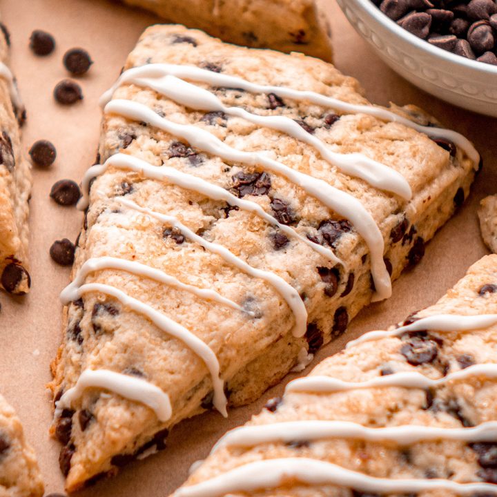 up close photo of 2 Chocolate Chip Scones with glaze drizzled on top