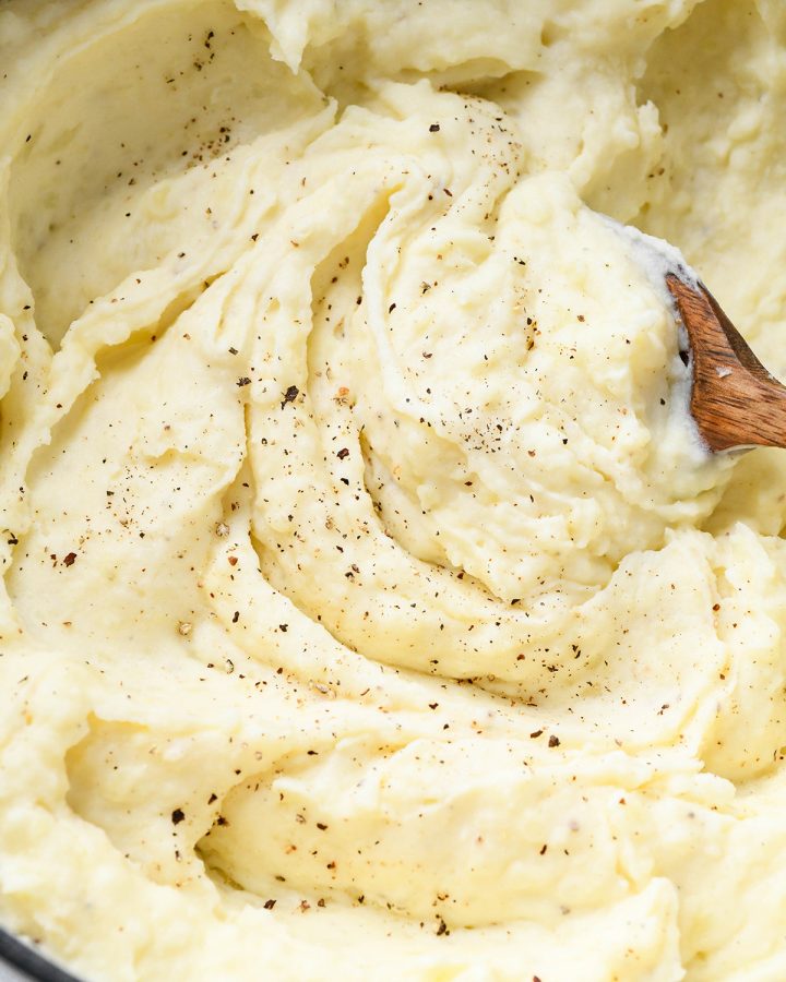 Cream Cheese Mashed Potatoes in a pot with salt and pepper sprinkled on top