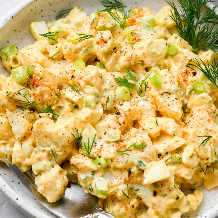 potato salad on a plate with a fork garnished with dill