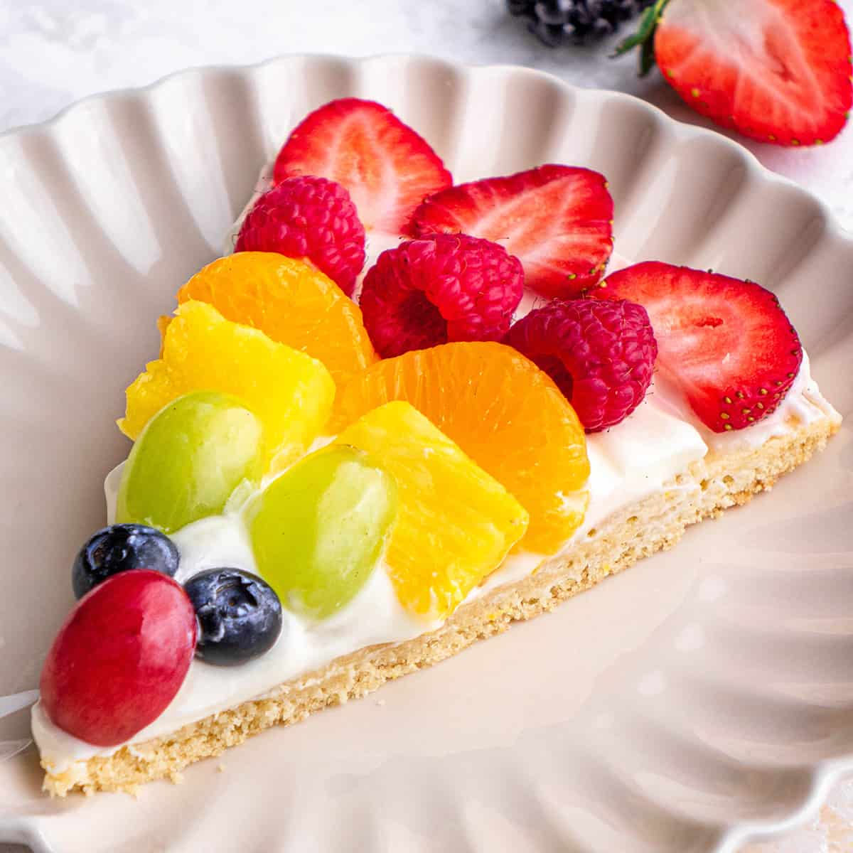 a slice of fruit pizza on a small plate