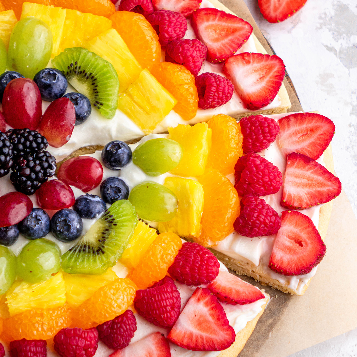 a slice cut out of a Fruit Pizza