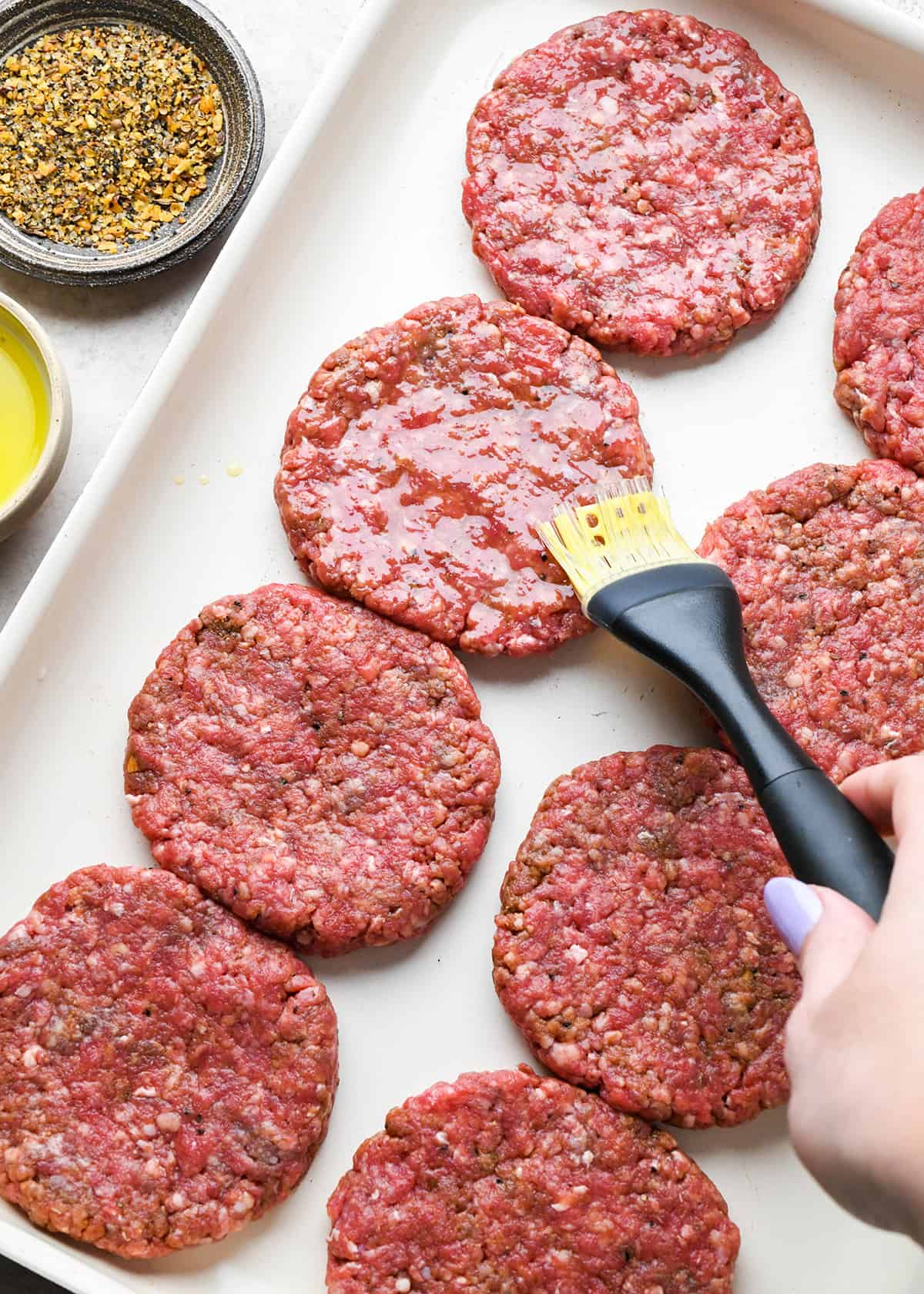 How to Make Hamburger Patties - brushing olive oil on the top of the burger patties