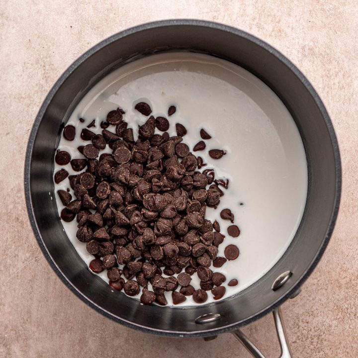 making the chocolate ganache in a small saucepan for this Oreo cheesecake recipe