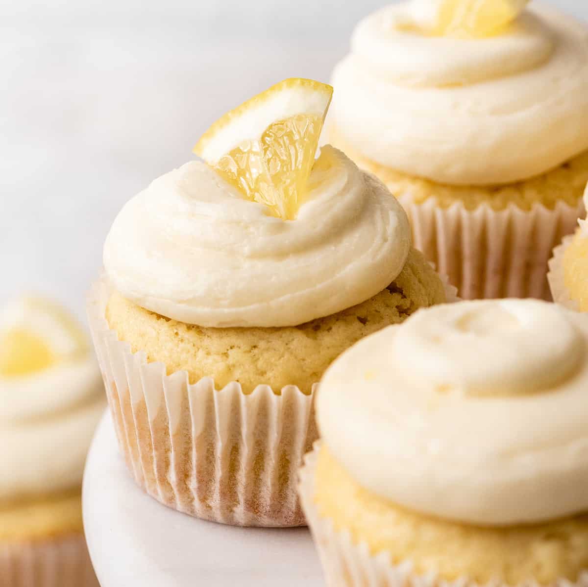 lemon frosting on top of 3 cupcakes