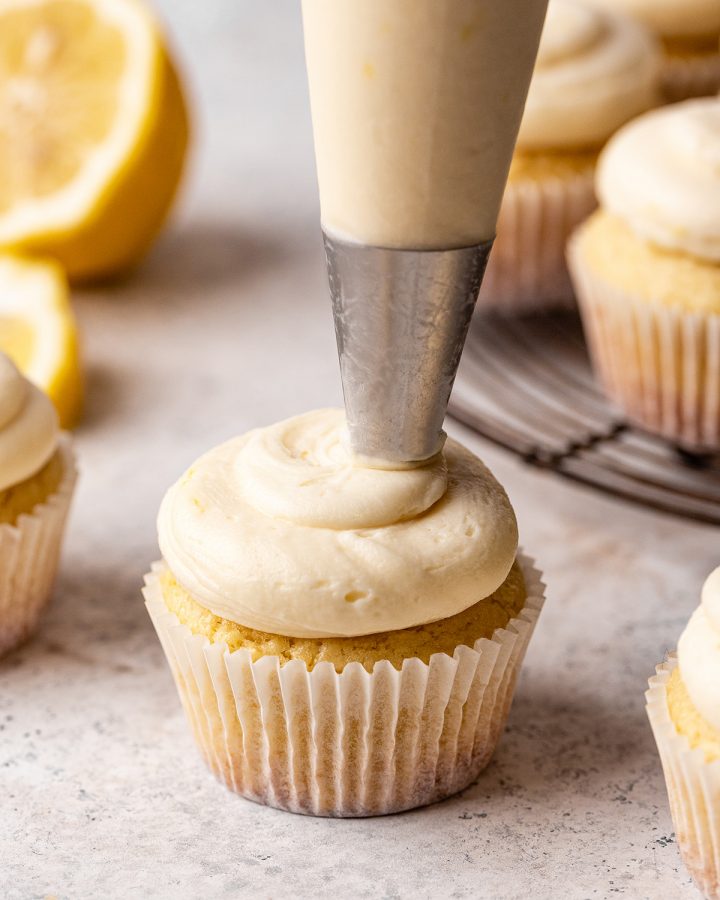 lemon frosting being piped onto a lemon cupcake