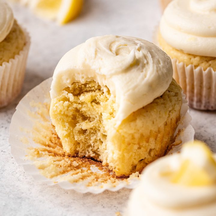 a frosted Lemon Cupcakes with a bite taken out of it