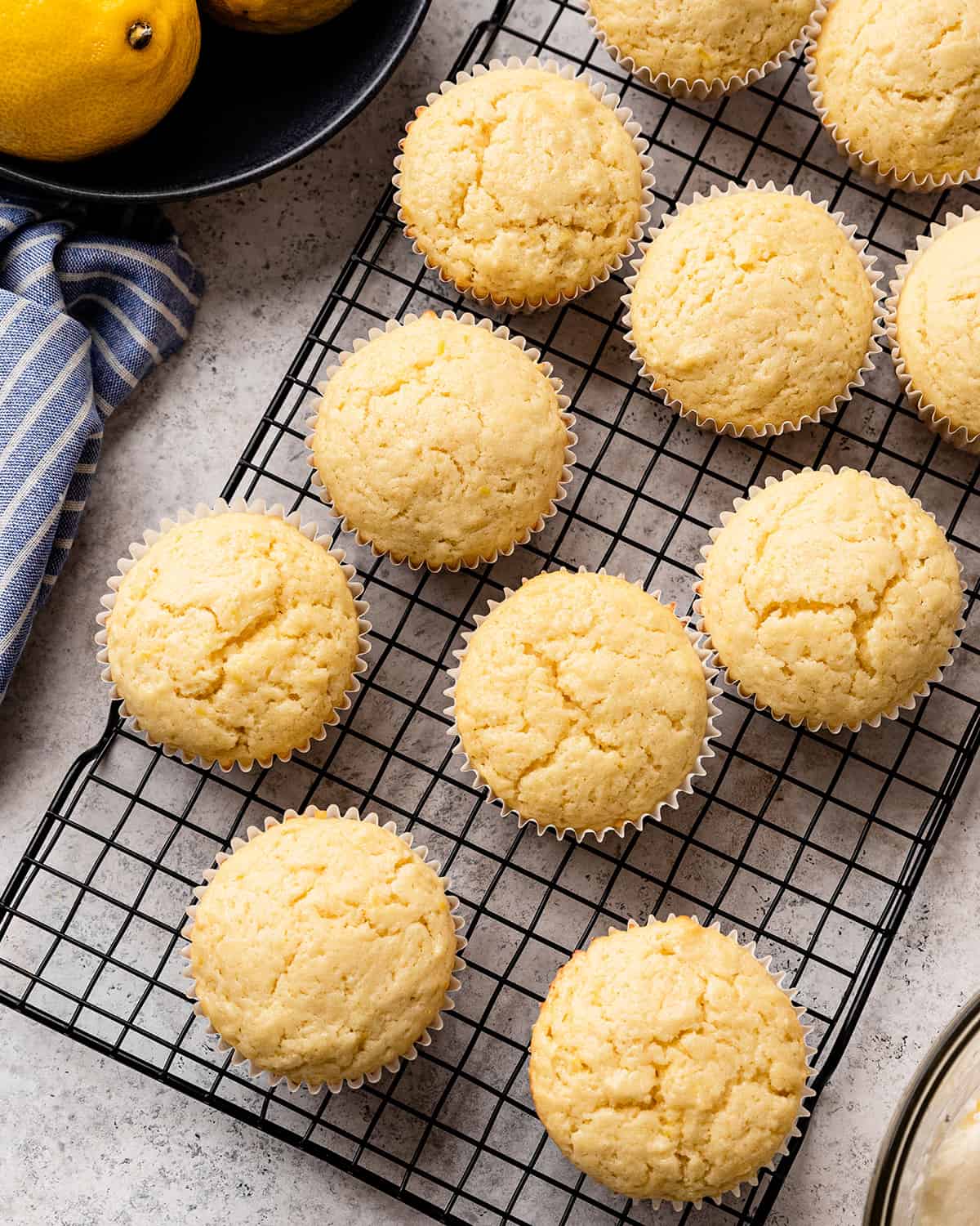 10 lemon cupcakes on a wire cooling rack