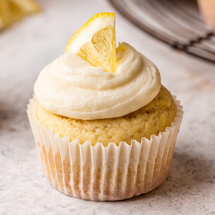 a Lemon Cupcake with frosting and piece of lemon on top