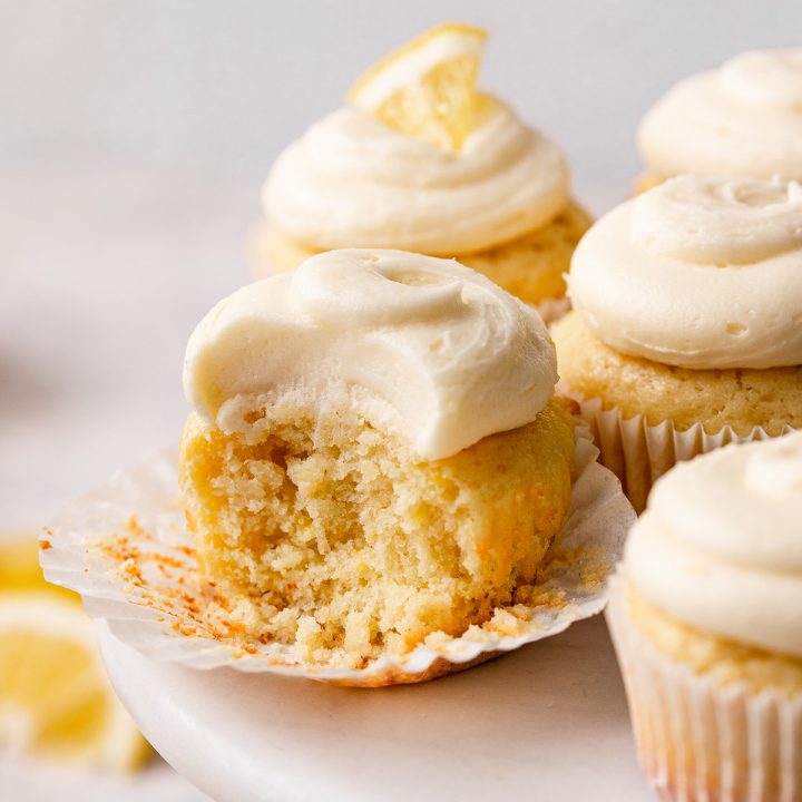 4 Lemon Cupcakes, one with a bite taken out of it