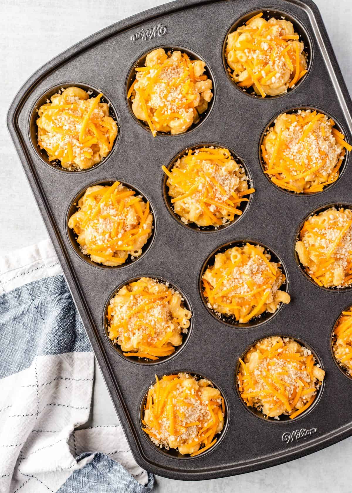 making mac and cheese cups - topping put over the mac and cheese in each well of a muffin pan before baking