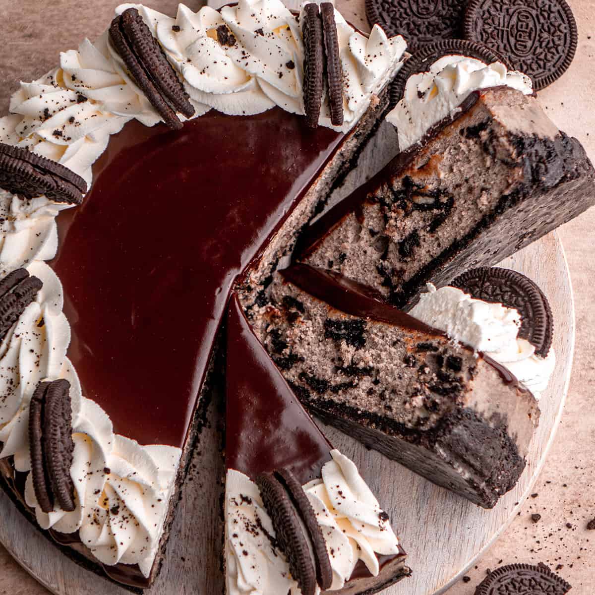 Oreo Cheesecake on a serving plate with 3 slices cut and two turned on their side so you can see the inside