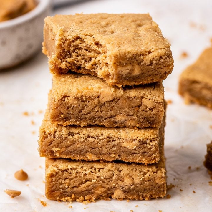 a stack of 4 Peanut Butter Cookie Bars, the top one has a bite taken out of it
