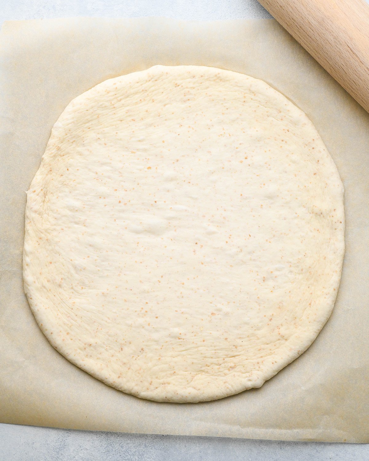 pizza dough rolled into a circle to make BBQ Chicken Pizza Recipe