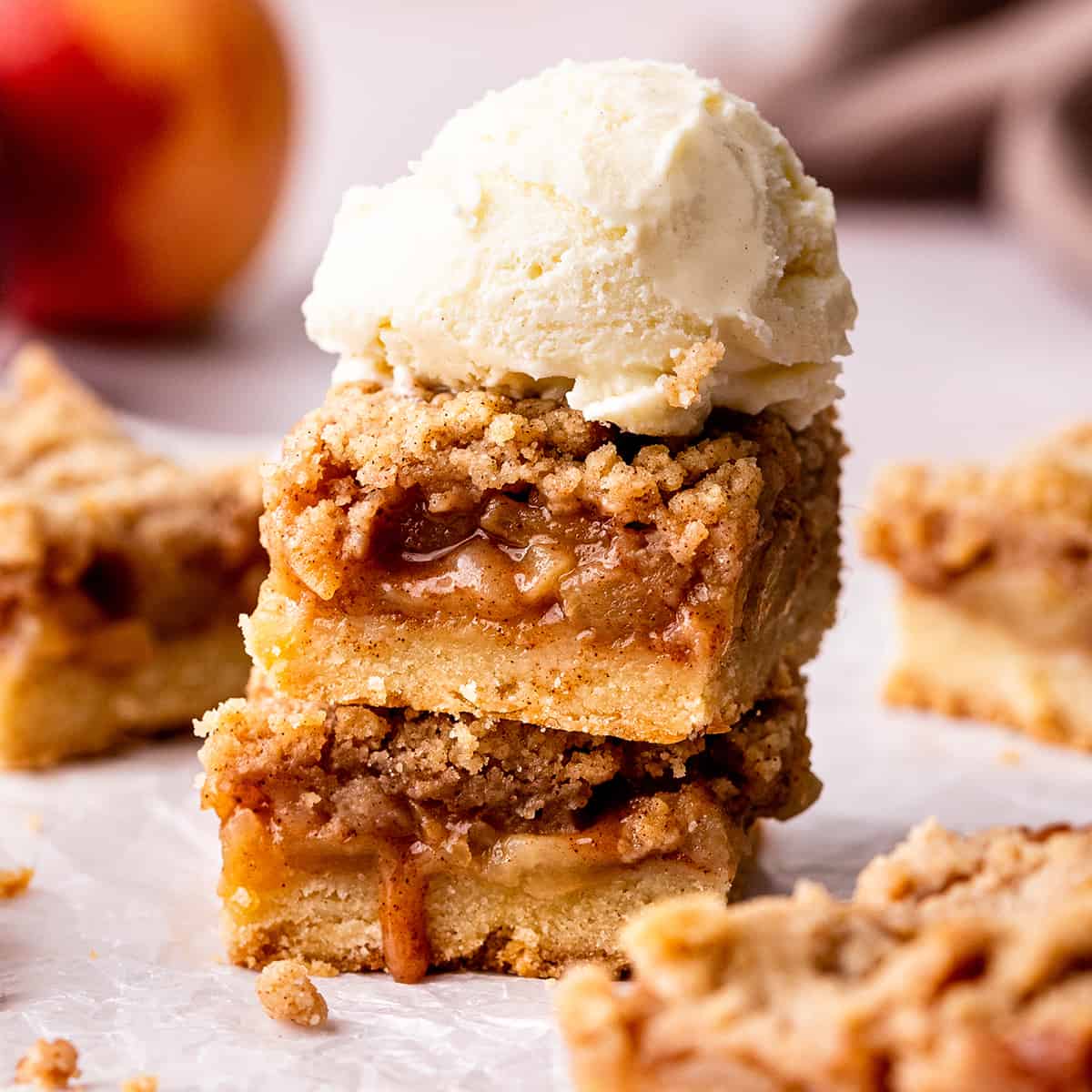 a stack of 2 Apple Pie Bars with ice cream on top
