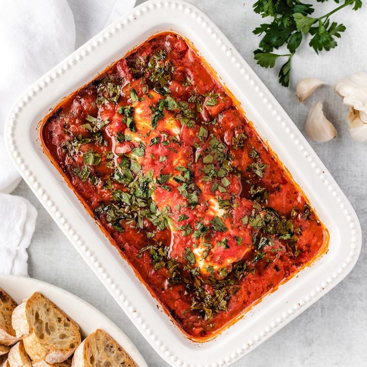 Baked Goat Cheese Dip in a white baking dish topped with parsley