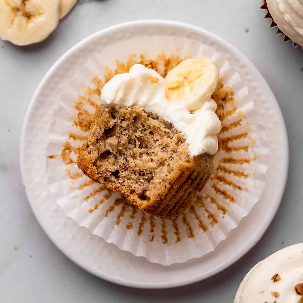 a banana cupcake on a plate with a bite taken out of it 