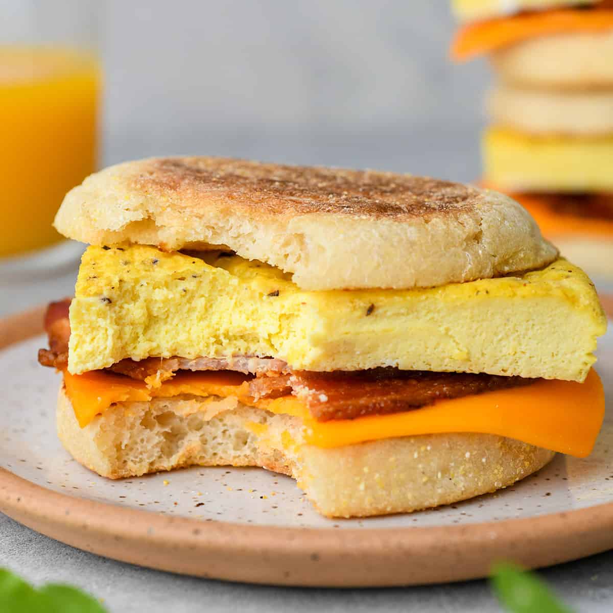 a Breakfast Egg Sandwich on a plate with a bite taken out of it