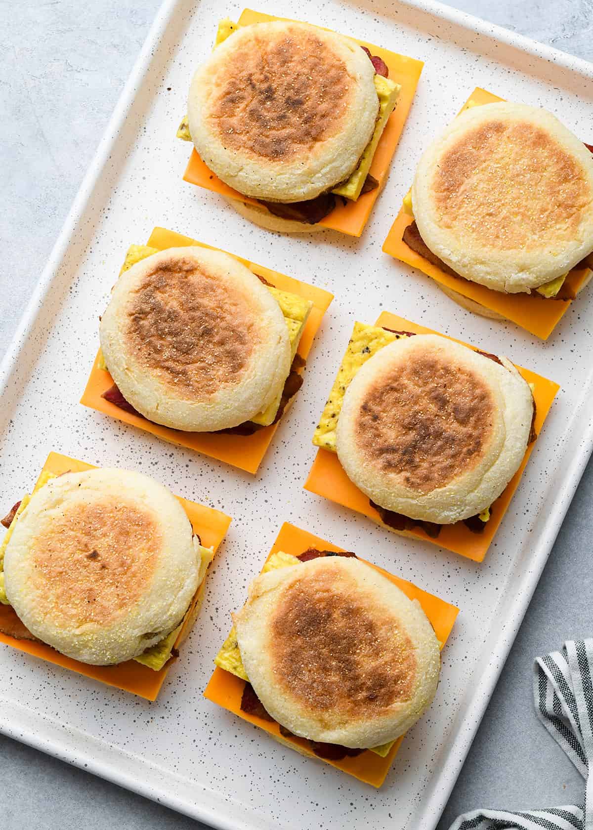 6 Breakfast Egg Sandwiches on a baking sheet