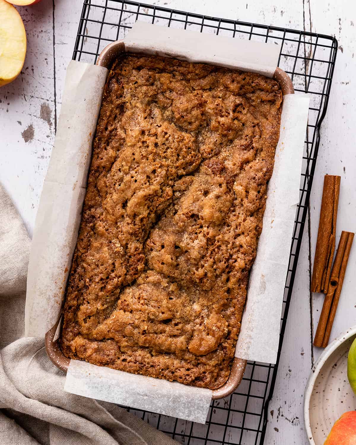 Cinnamon Apple Bread in a baking pan cooling on a wire rack