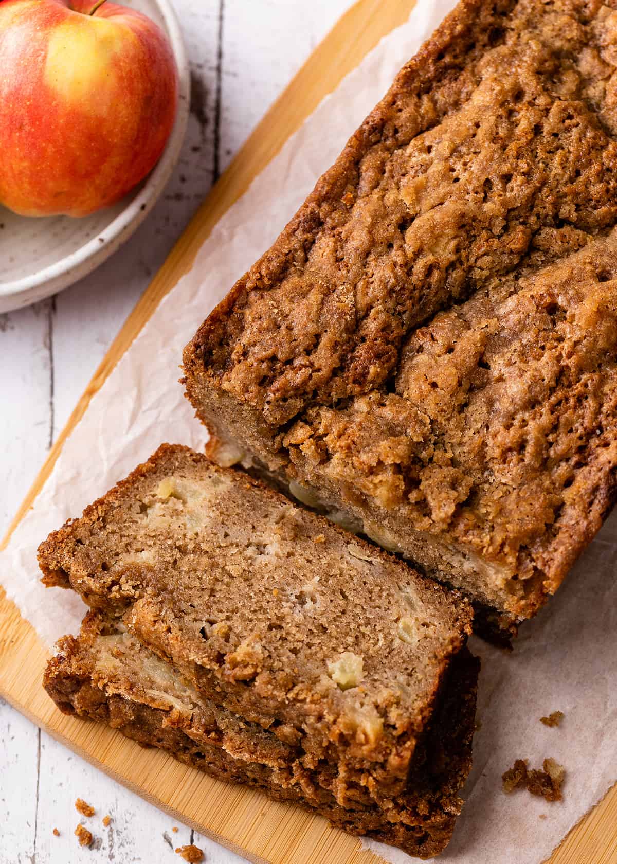 a loaf of Cinnamon Apple Bread with two slices cut out of it