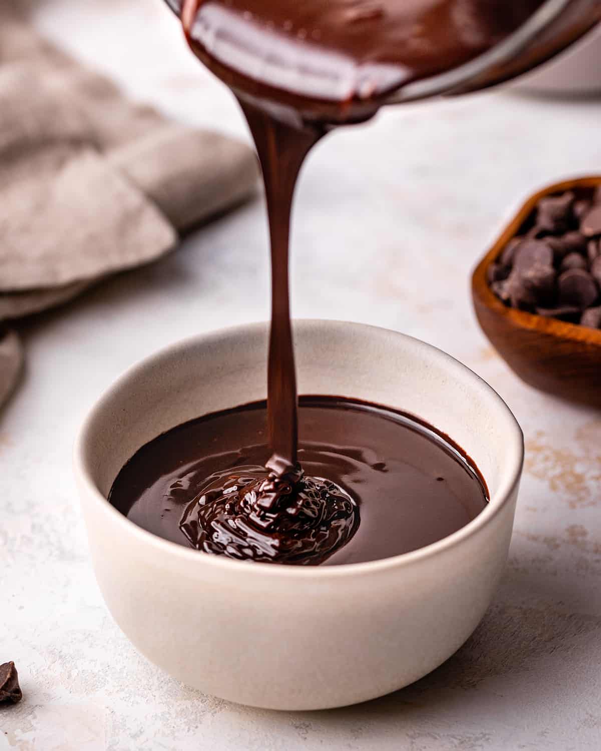 chocolate sauce being poured into a bowl