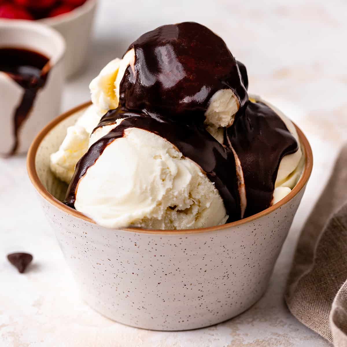 homemade chocolate sauce on top of vanilla ice cream