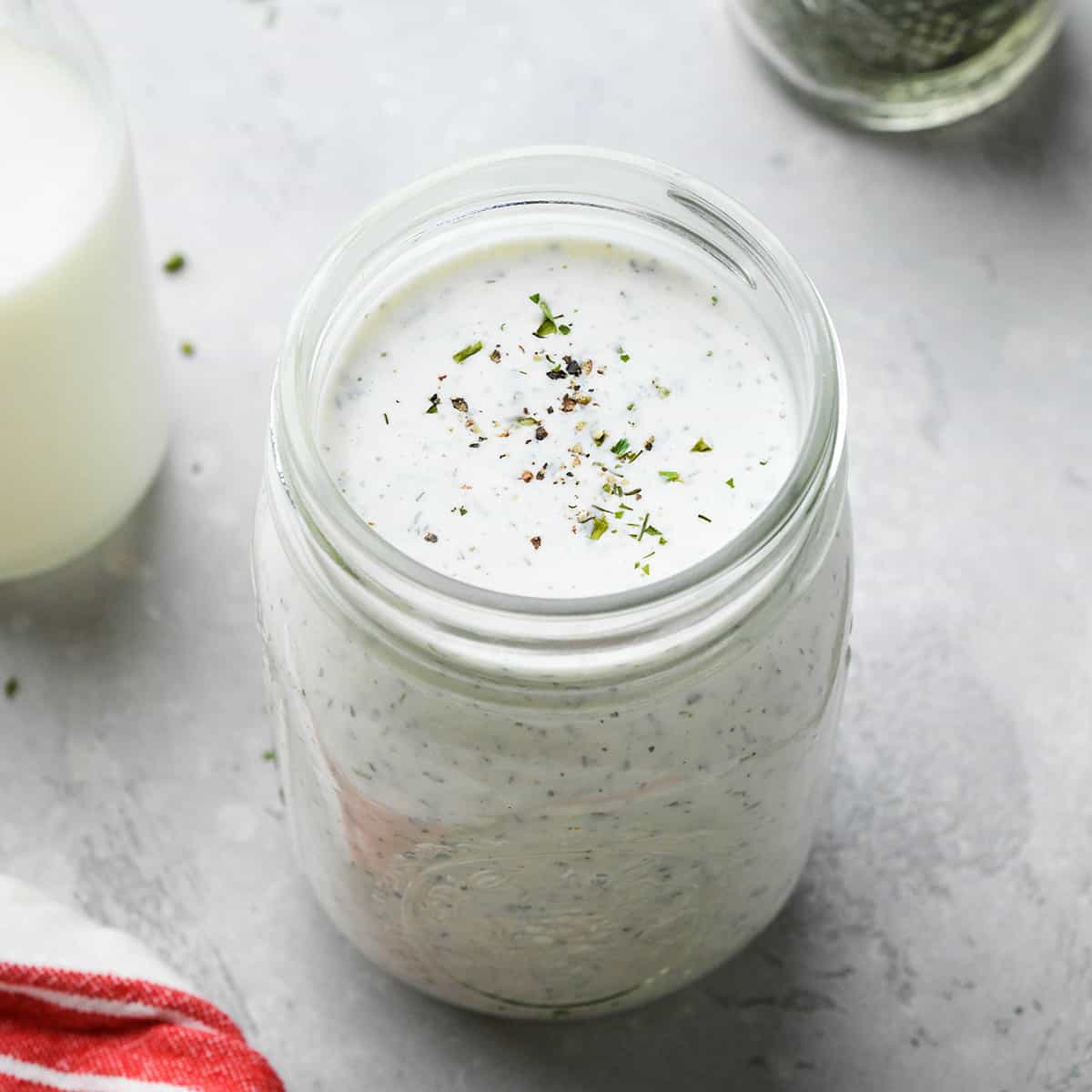 a glass jar of ranch dressing made with Ranch Dressing Mix