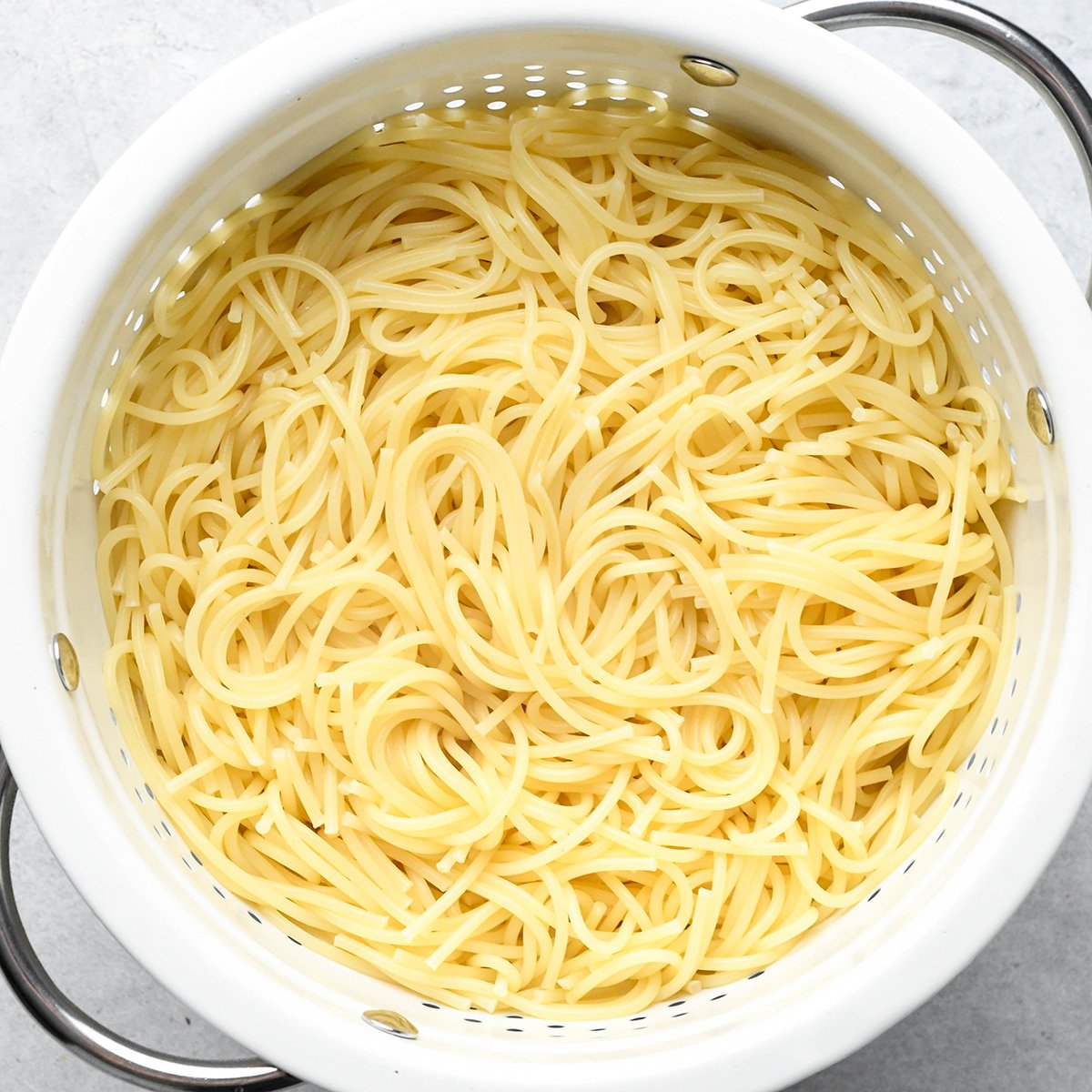noodles draining in a colander to make Pesto Pasta Recipe