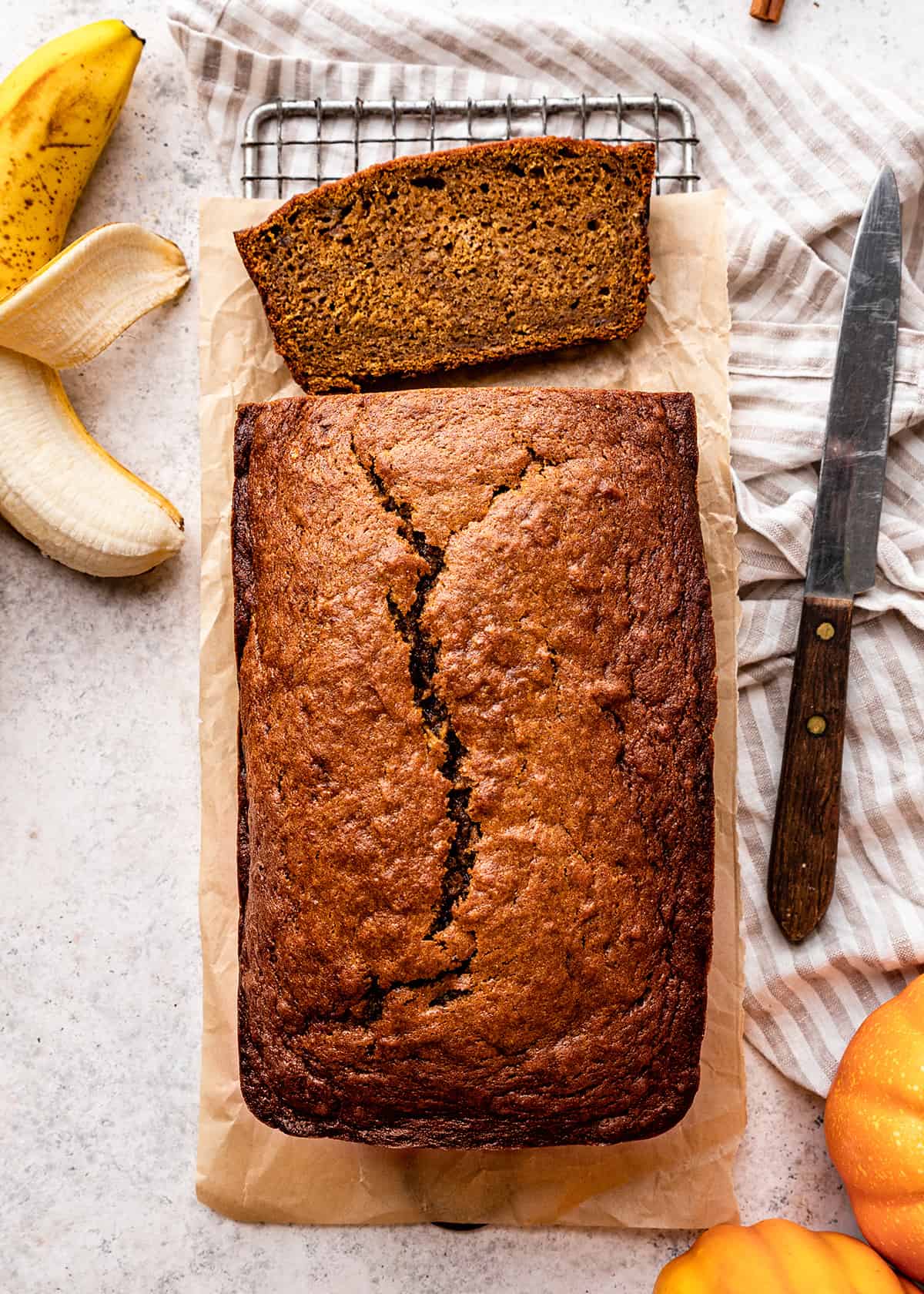 a loaf of Pumpkin Banana Bread with one slice cut out of it