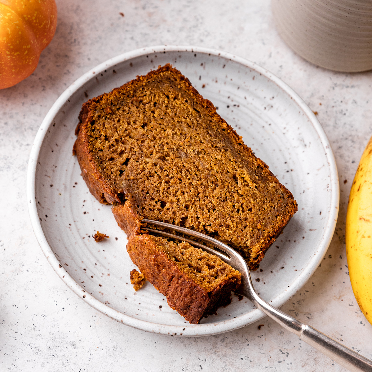a slice of Pumpkin Banana Bread on a plate with a fork