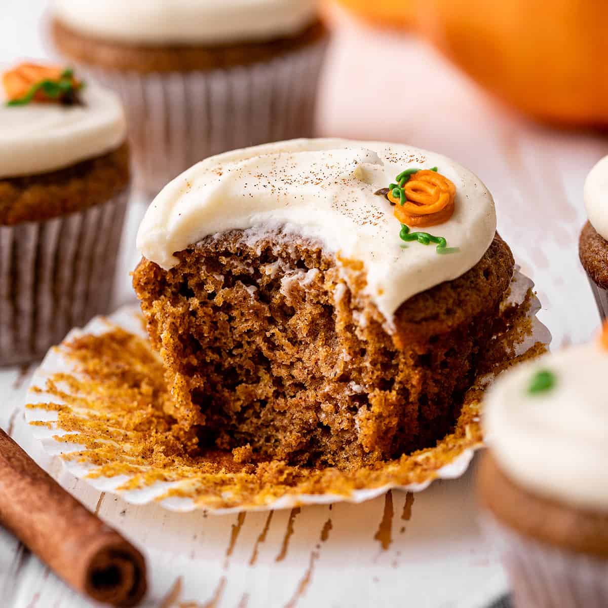 a frosted Pumpkin Cupcake with a bite taken out of it
