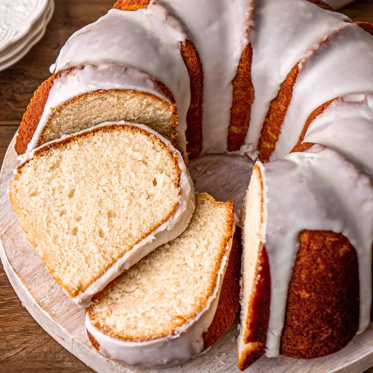 Vanilla Bundt Cake with 2 slices cut out of it