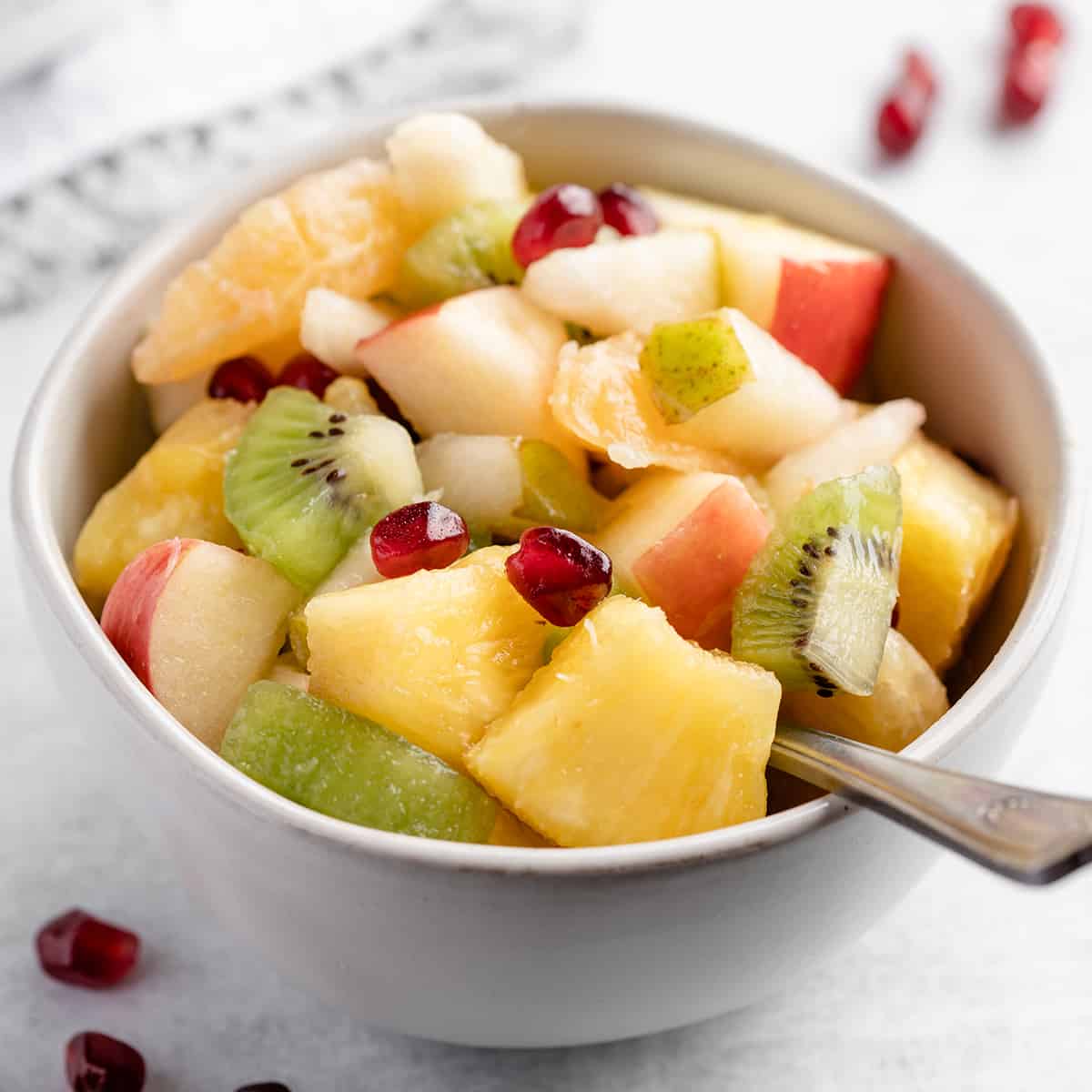 a small white bowl filled with Winter Fruit Salad