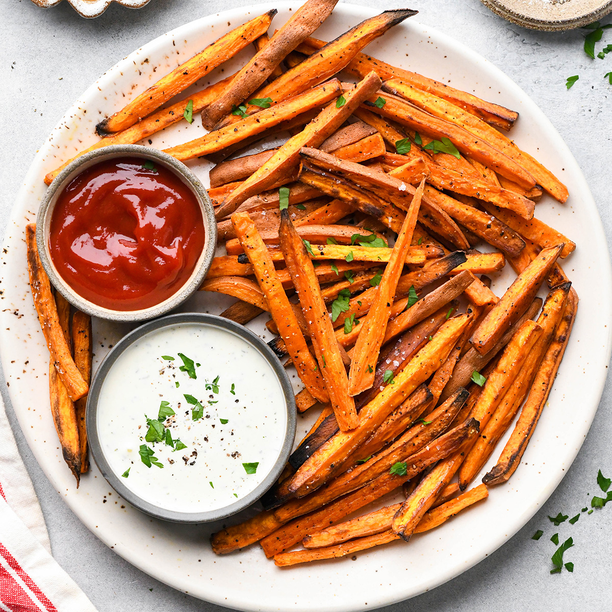 a plate of Baked Sweet Potato Fries with two dipping sauces