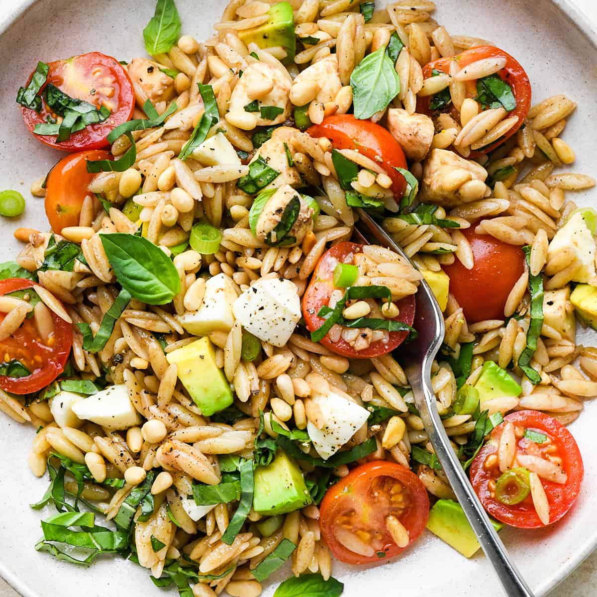 Caprese Orzo Salad on a plate with a fork