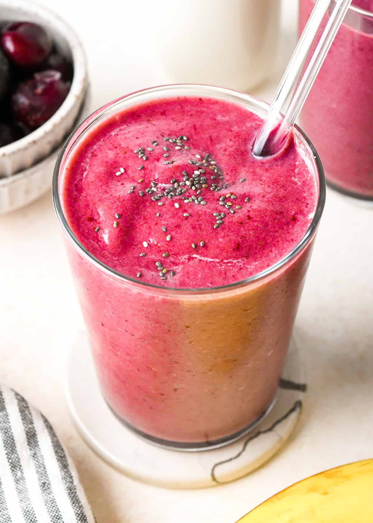 Cherry Smoothie in a glass topped with chia seeds
