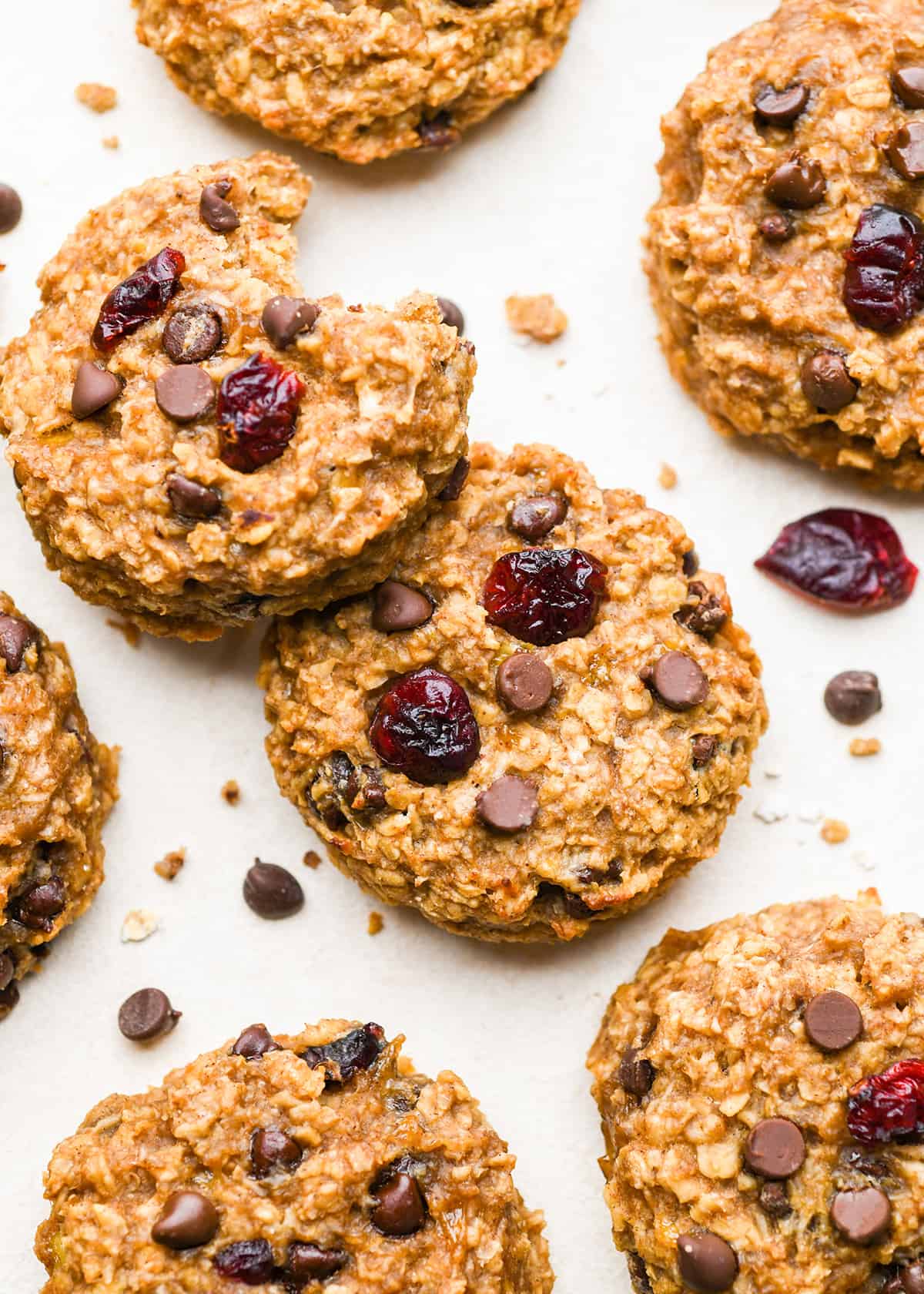 7 Breakfast Cookies with chocolate chips and dried cranberries, one with a bite taken out of it