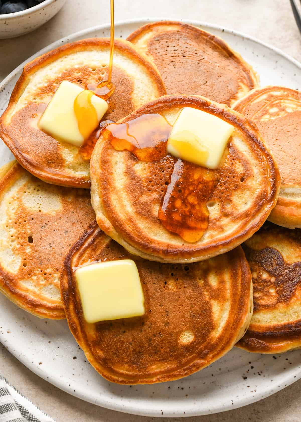 7 pancakes made with Homemade Pancake Mix on a plate with butter and syrup 