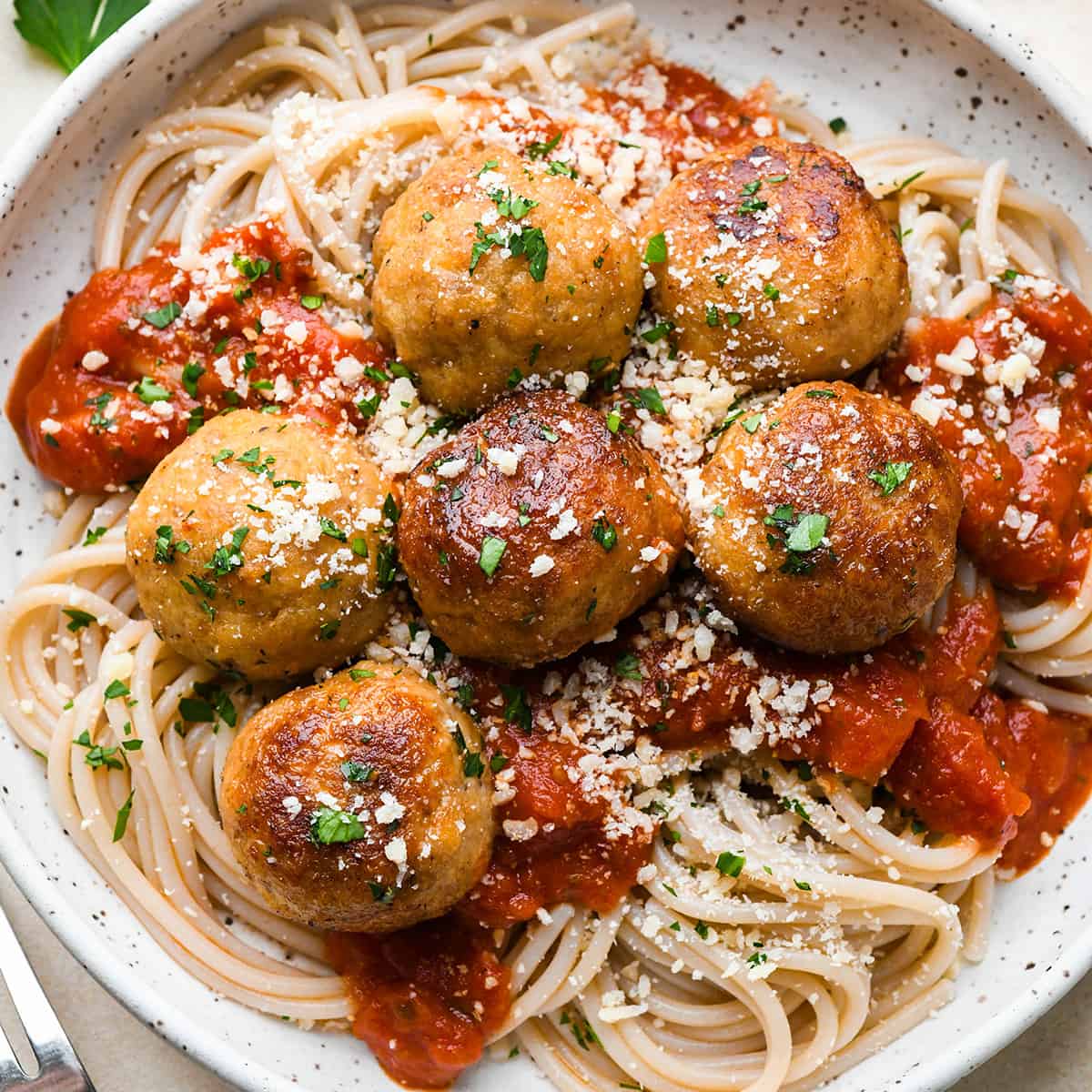 Chicken Meatballs on top of spaghetti with marinara sauce